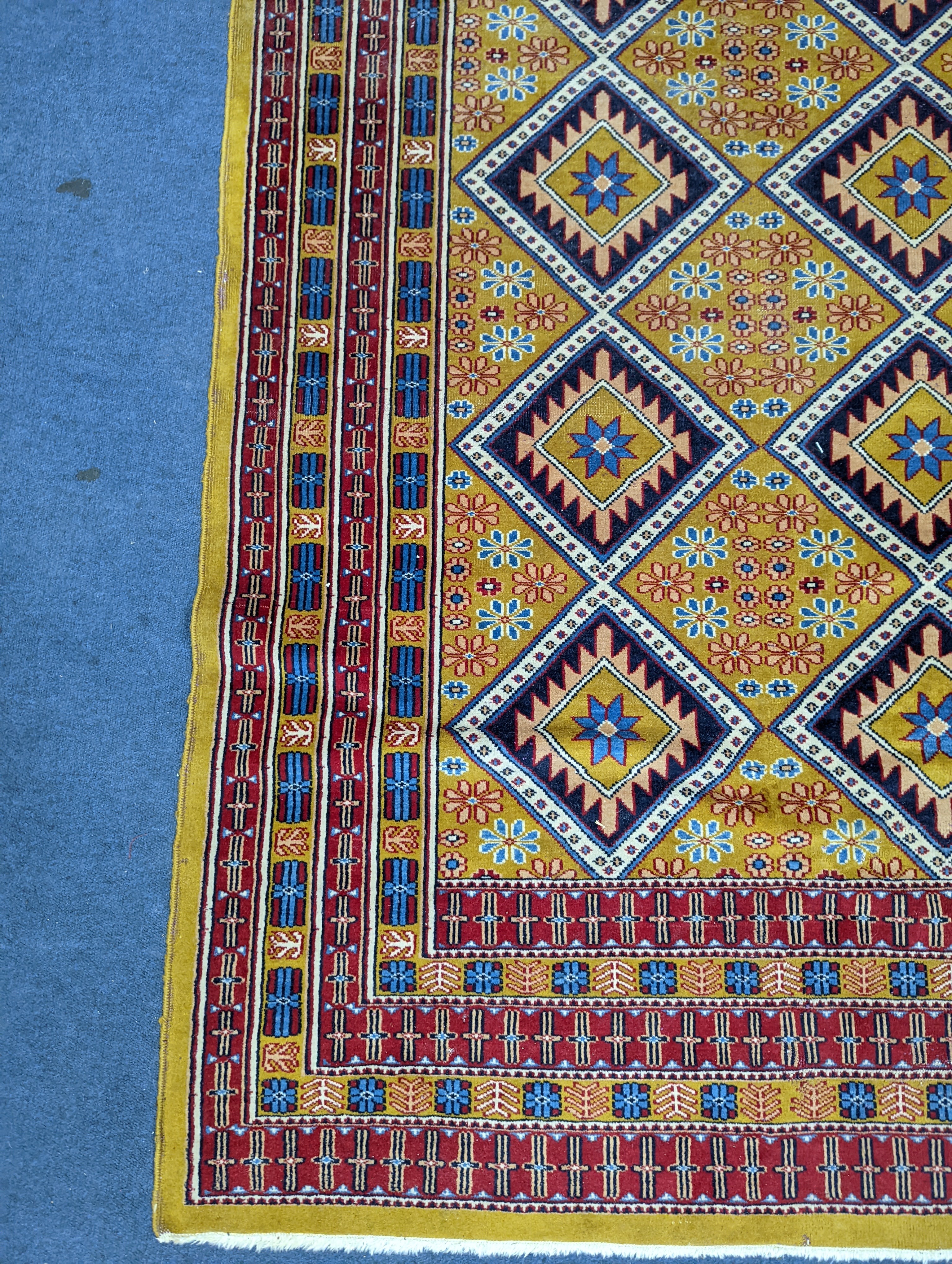 A Caucasian style gold ground rug, 190 x 124cm